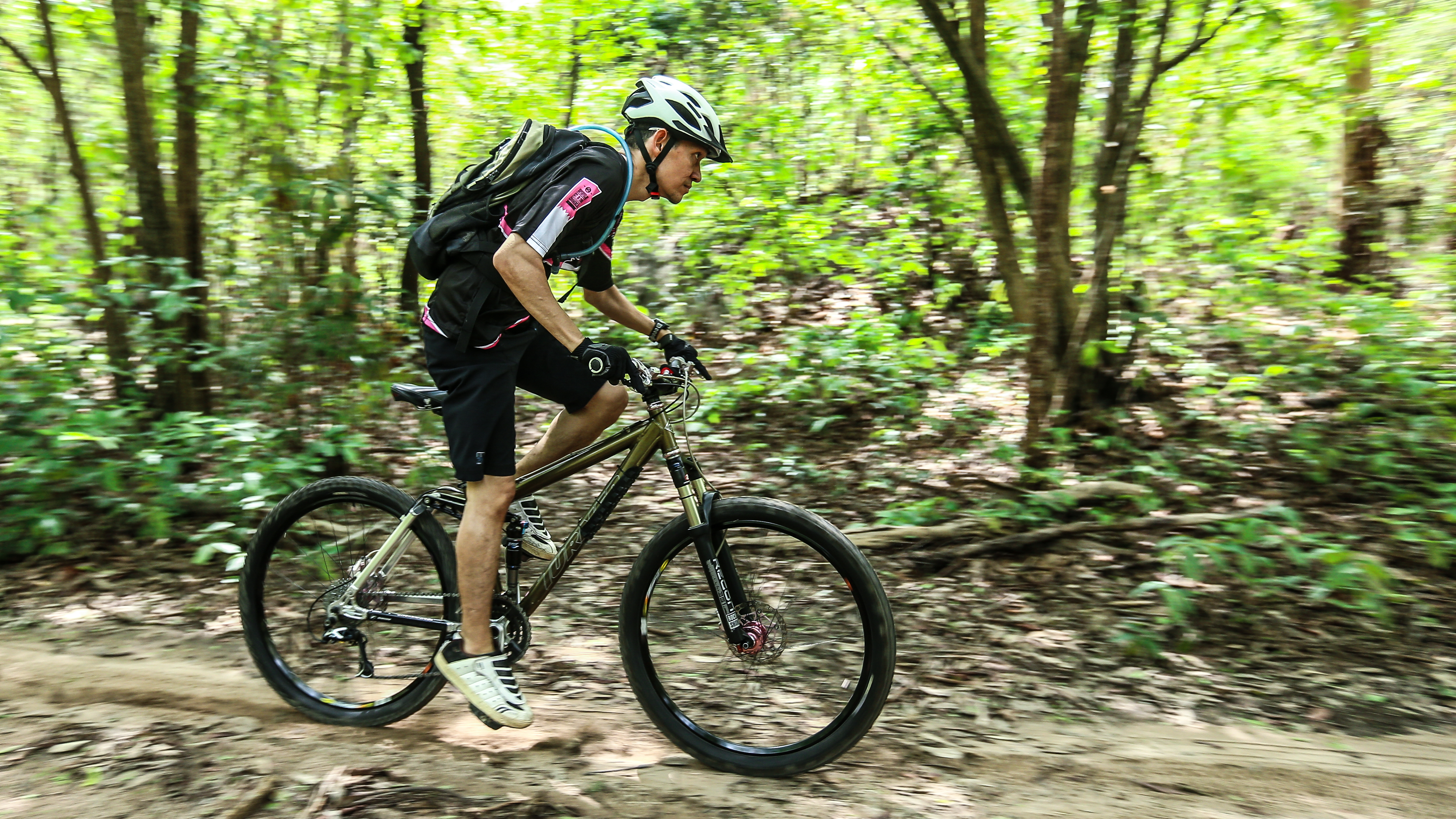 Man mountain biking on trail